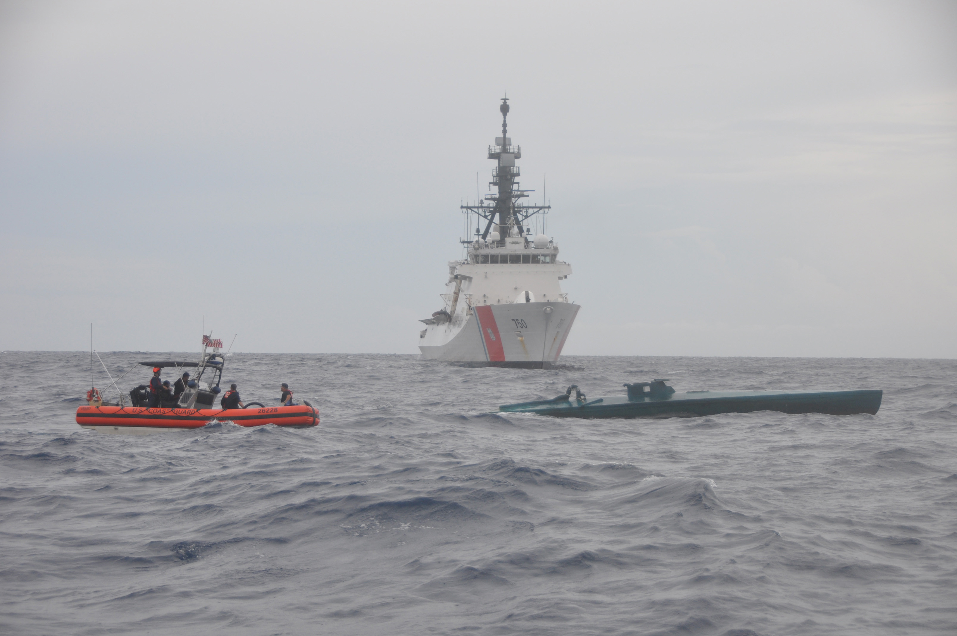 A Coast Guard Cutter Bertholf boarding team aboard an Over the Horizon Long-Range Interceptor boat conducts an interdiction of a self-propelled semi-submersible vessel suspected of smuggling 7.5 tons of cocaine in the Eastern Pacific Ocean, Aug. 31, 2015. The seized contraband is worth an estimated $227 million. (U.S. Coast Guard photo) 