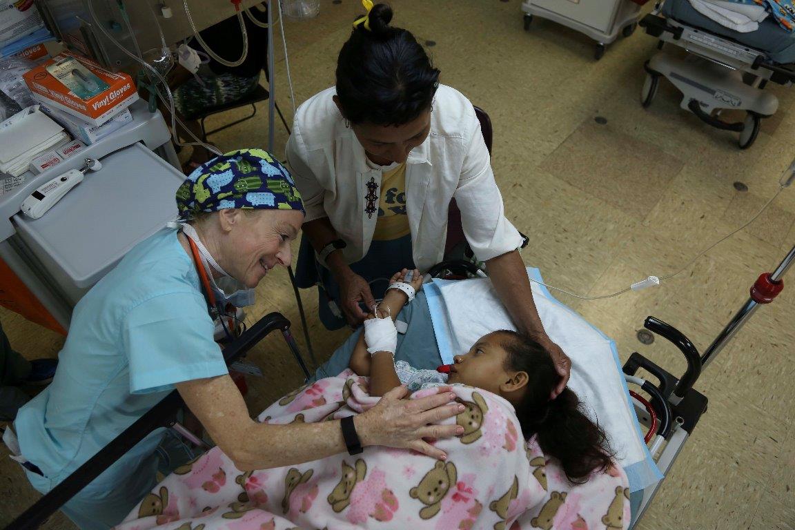 Dr. Judith Brill, a physician volunteering with the non-governmental organization Operation Smile, comforts a Nicaraguan patient in the post-operating room aboard USNS Comfort during Continuing Promise 2015. (U.S. Navy photo)